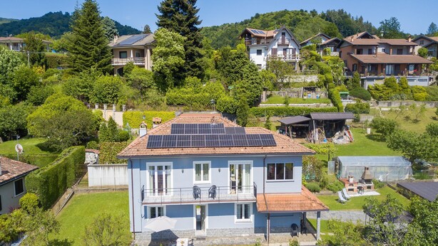 A residential building with a balcony, solar panels, and a garden. - Zio Enry Garden Orta Lake (Armeno)