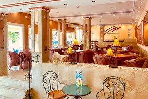 A hotel lobby with a reception desk, wicker furniture, and a staircase. - Marbella Resort 9 Pool Whirlpool Sauna (Marbella)