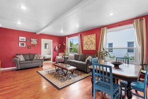 Relax in this inviting living room with two sofas, a coffee table, and a dining table.