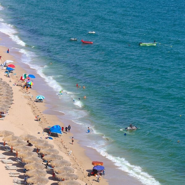 On the beach, sun loungers, beach towels