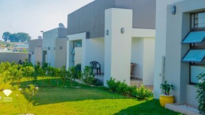 A row of modern, single-story residential buildings with flat roofs, satellite dishes, and small balconies. - Sunset Bliss Paradise in Lilongwe (Lilongwe)