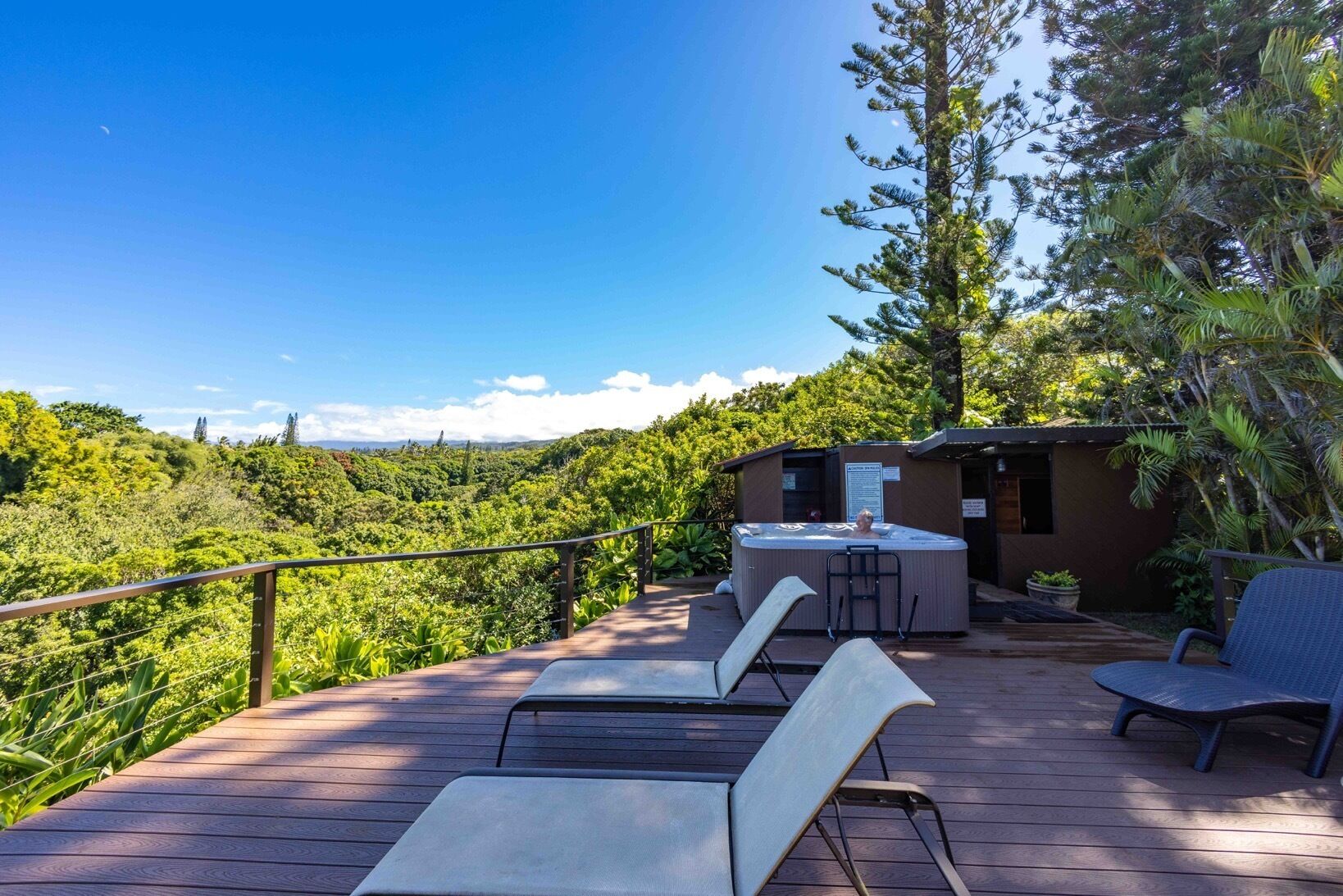 A hot tub area with a view of a forested landscape.