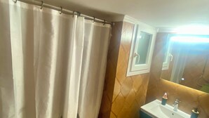 A bathroom with a shower curtain featuring a cityscape design, a sink with a mirror above it, and a tiled floor. - Sweety flat Marina Zeas Piraeus nearby the sea (Pireas)