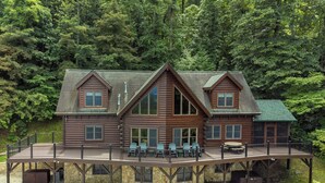 A log cabin with a deck and outdoor seating area. - Grandview Lodge | Large 4 Bedroom Mountain Cabin with Hot Tub & Views! (Old Fort)