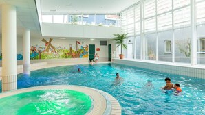 An indoor swimming pool with clear blue water, a mural on the wall, and large windows allowing natural light. - Nice Hotel Room Only 1 km From Volendam Centre (Volendam)