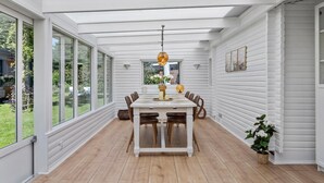 A dining area with a white table, wooden chairs, and a hanging light fixture. - Amazing home in Væggerløse with WiFi (Væggerløse)