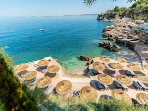 On the beach, sun-loungers, beach towels