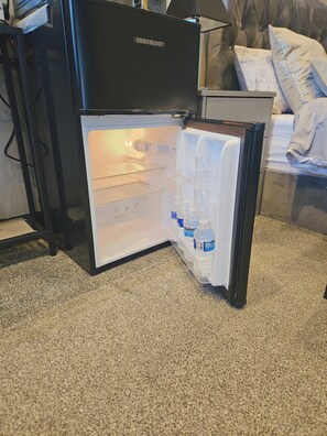 Features a spacious refrigerator with a convenient water dispenser.