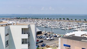 A marina with numerous boats docked, a parking area with cars, and a building with a sign reading "PORT DE PECH". - Port Arcachon by Interhome (Arcachon)