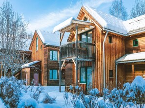Guests can enjoy a balcony with multiple windows, some with shutters, from this cabin-style building.