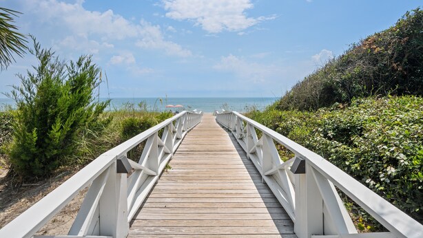A wooden boardwalk leading to the beach with white railings. - Screened Porches, Decks, Rockers, Hammocks And An Upstairs Balcony With Ocean Views 5 Bedroom Home by Peace Vacations (Georgetown)
