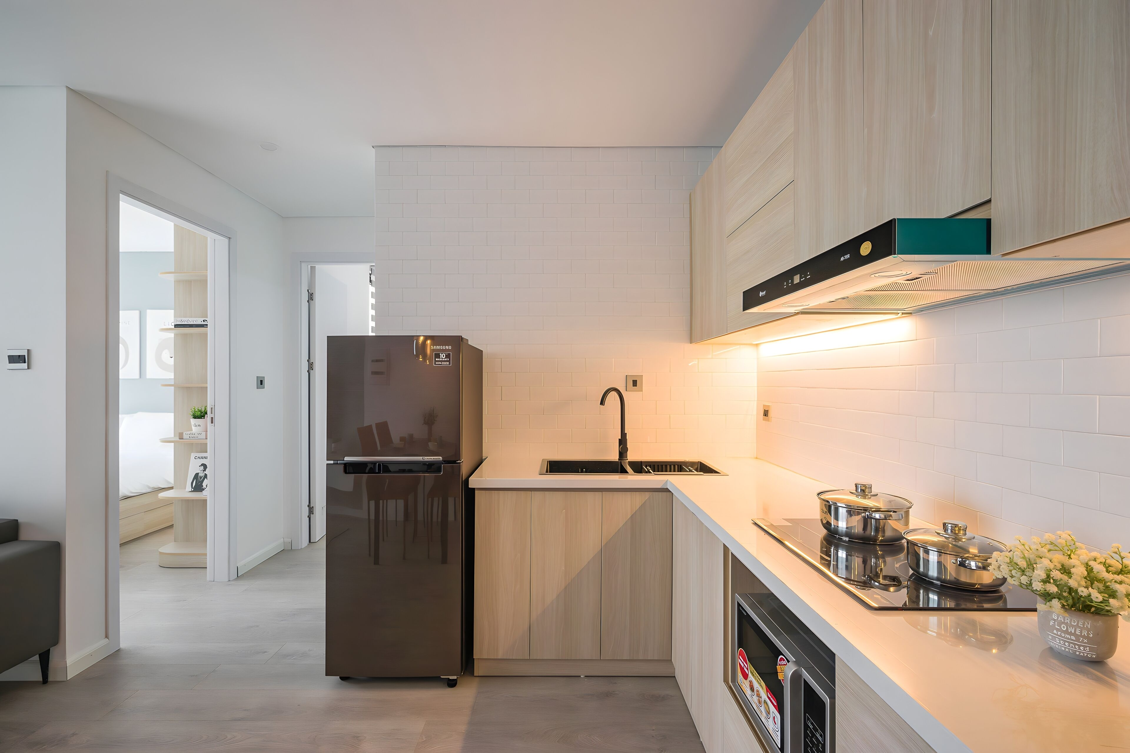 A modern kitchen with a built-in refrigerator, a sink, and a stove.