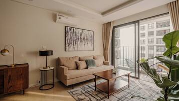 A modern living room with a sofa, coffee table, and a large window.