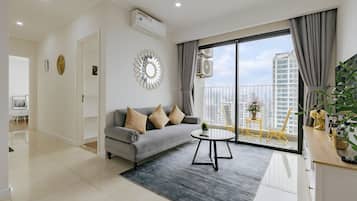 Business Apartment, 2 Bedrooms, Balcony, City View | Living area | 60-inch Smart TV with cable channels, books, pay movies