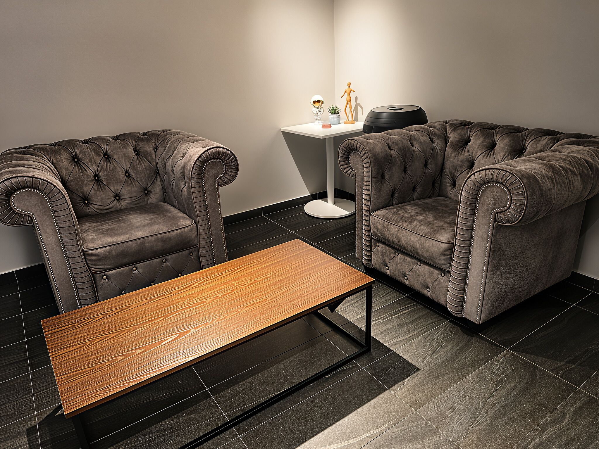 A modern living room with two tufted sofas, a small round table, and a side table with a potted plant.