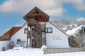A wooden building with a staircase, a sign reading 'Landhaus Alpina,' and snow-covered surroundings. - Apartment 'Fewo Rotwand' with Shared Terrace, Shared Garden and Wi-Fi (Willingen (Upland))