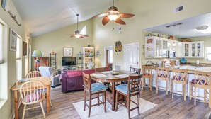 A spacious living area with a wooden dining table, chairs, and a ceiling fan. - Steps to Crystal Beach! Family & Pet-Friendly Home (Crystal Beach)