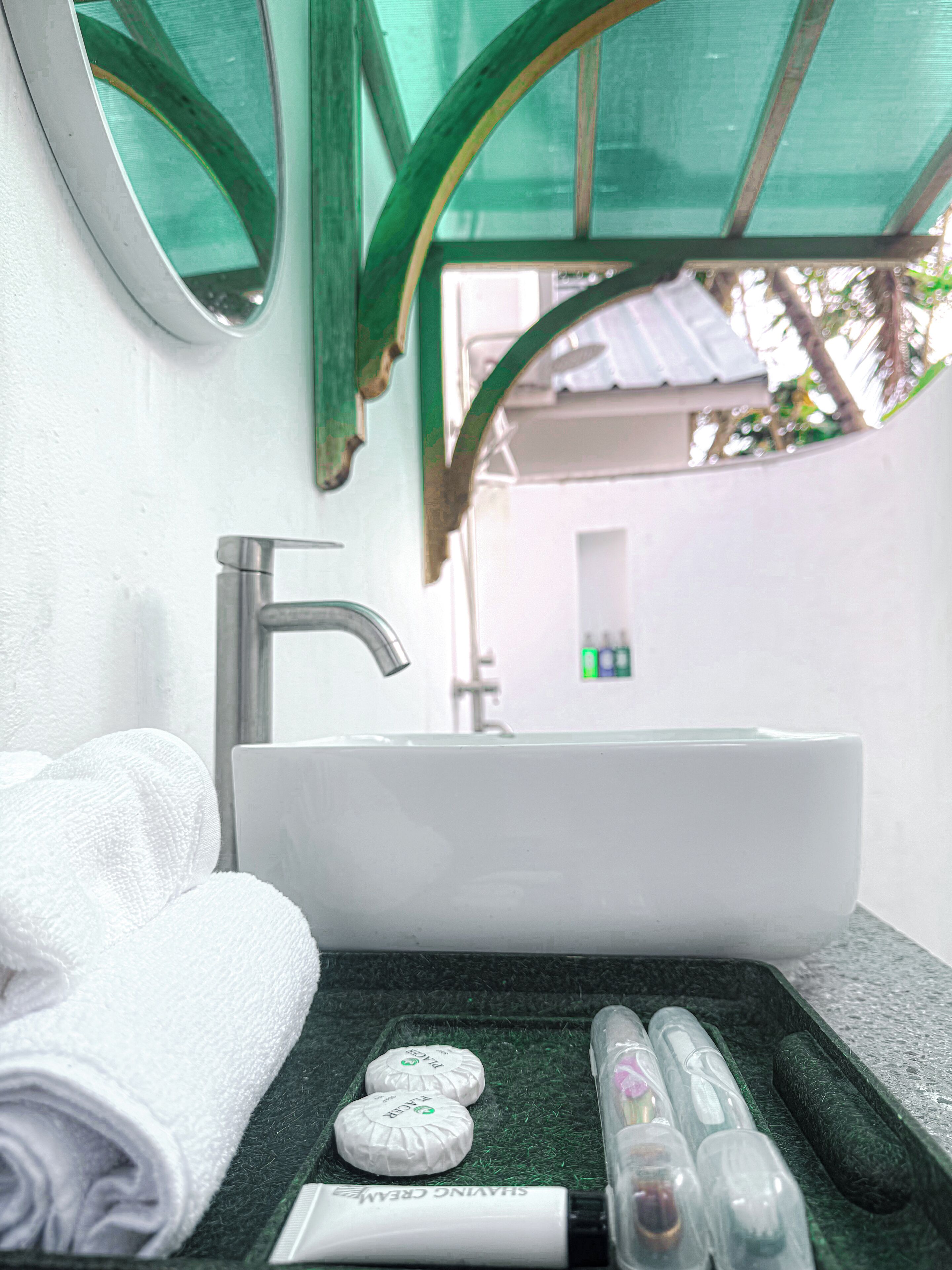 A bathroom with a sink, a towel, and toiletries.