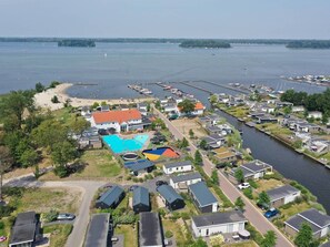 A residential area with houses, a swimming pool, and a marina.