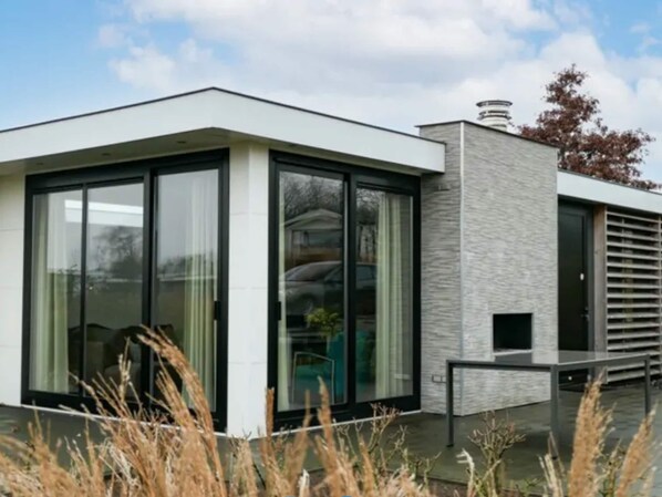 A modern building with large glass windows and a stone facade.