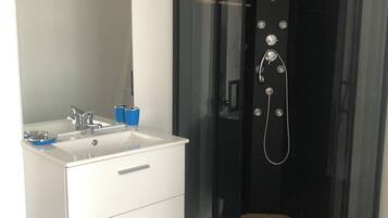 Shower, hair dryer, towels, toilet paper