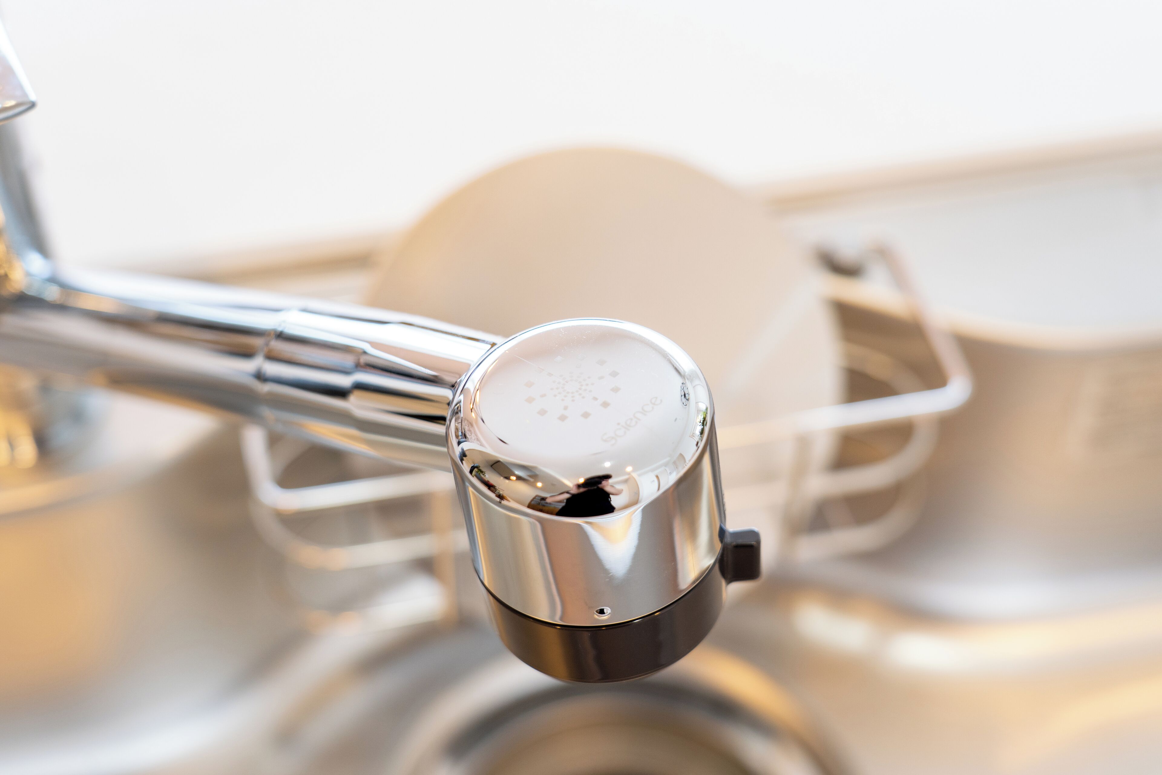 A kitchen faucet with a metallic finish and a control knob.