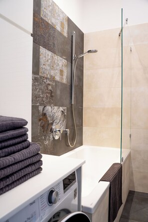 Apartment | Bathroom | Bathtub, free toiletries, hair dryer, soap