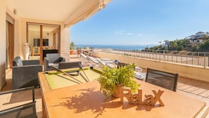 A balcony with a pool table, lounge chairs, and a view of the sea. - Marbella Mountain With sea View and Pool (Marbella)