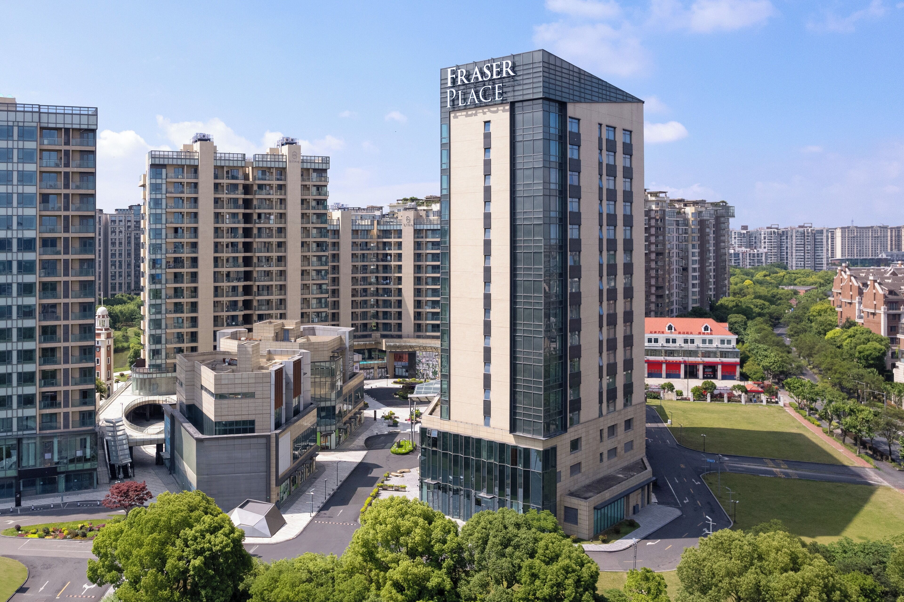 A high-rise building labeled "Fraser Place" with multiple floors, surrounded by other residential buildings and greenery.