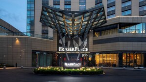 A modern hotel entrance with a distinctive glass and steel canopy structure. - Fraser Place Wujiaochang Shanghai (Shanghai)
