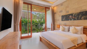 A modern bedroom with a large bed, a TV, and a sliding glass door leading to a garden. - Bali Made Escape (Bangli)