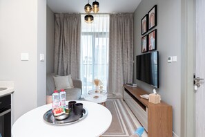 Deluxe Apartment, 1 Bedroom, Lake View | Living area | 50-inch Smart TV with digital channels