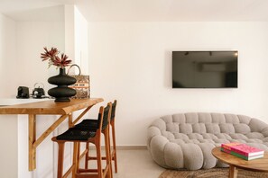 Junior Suite with Sea View and Indoor Hot tub | Living area | 55-inch Smart TV with digital channels, Netflix, streaming services