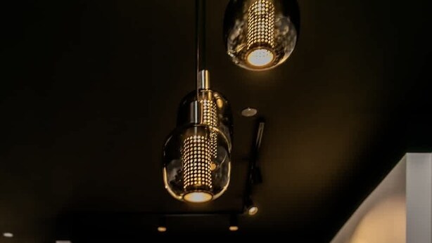 A round dining table with a vase of dried flowers, two wine glasses, and a bowl. - B2 - Two Bedroom Apartment with Balcony (Reykjavík)