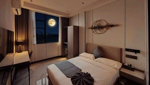 A modern hotel room with a large bed, a desk, and a view of the moon through the window. - Eden Hotel  (Kinshasa)