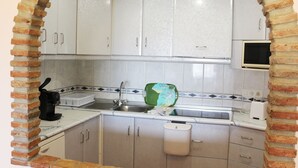 A kitchen with white cabinets, a sink, a microwave, and a toaster. - M & M Neptuno Torrecilla Beach. With Pool (Nerja)