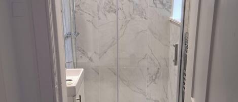 Shower, towels, soap, toilet paper