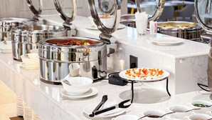 A buffet setup with multiple food stations, including a hot pot and various dishes. - Landmark Vientiane Life Center (Vientiane)
