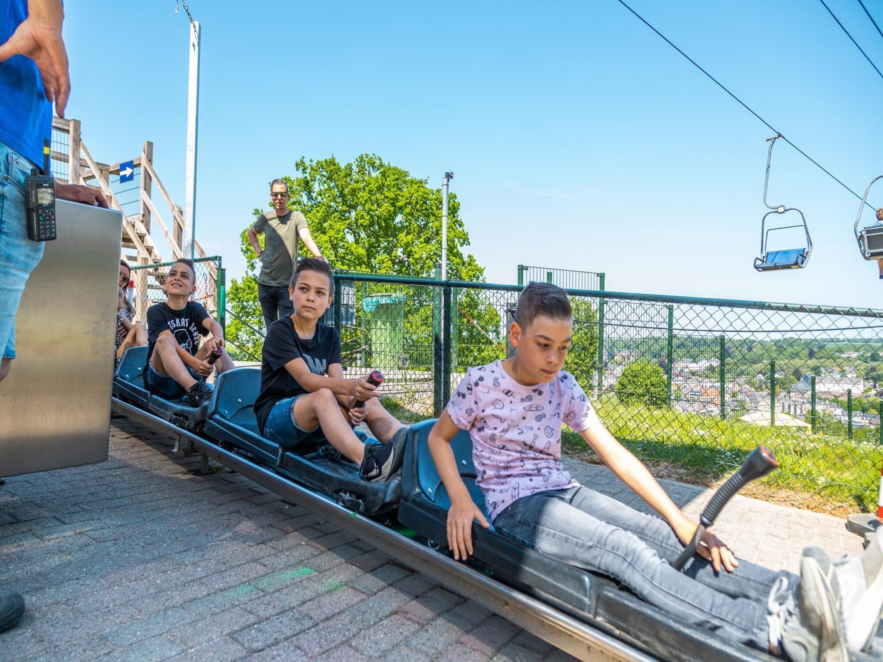 A roller coaster with passengers seated in the cars.