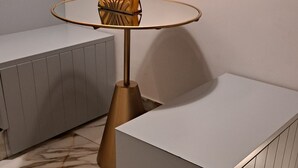 A modern room with a central round table, a sofa, and a cabinet. - Elegant Suite in the heart of Naples  (Napoli)