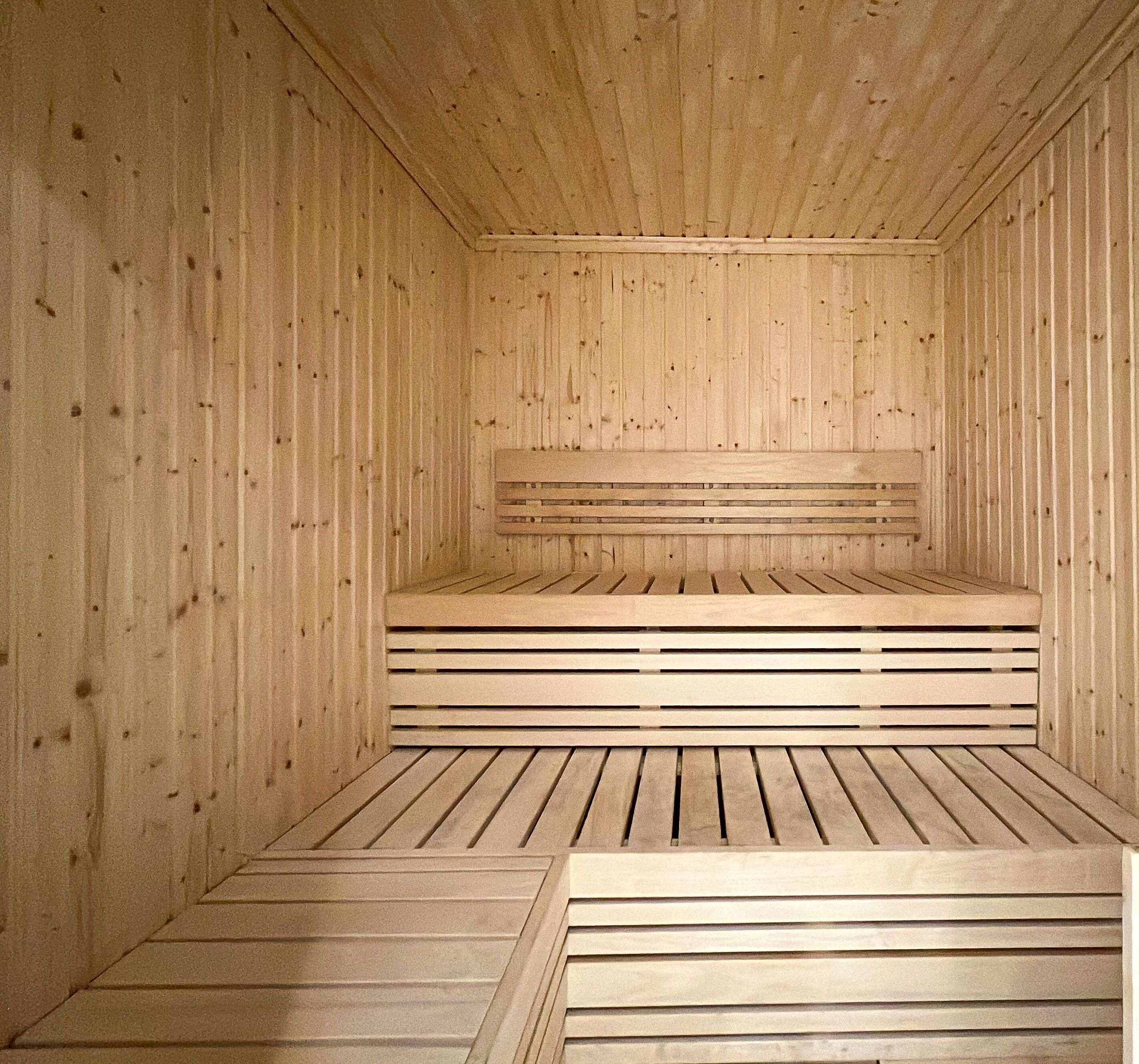 A sauna with wooden walls and benches.