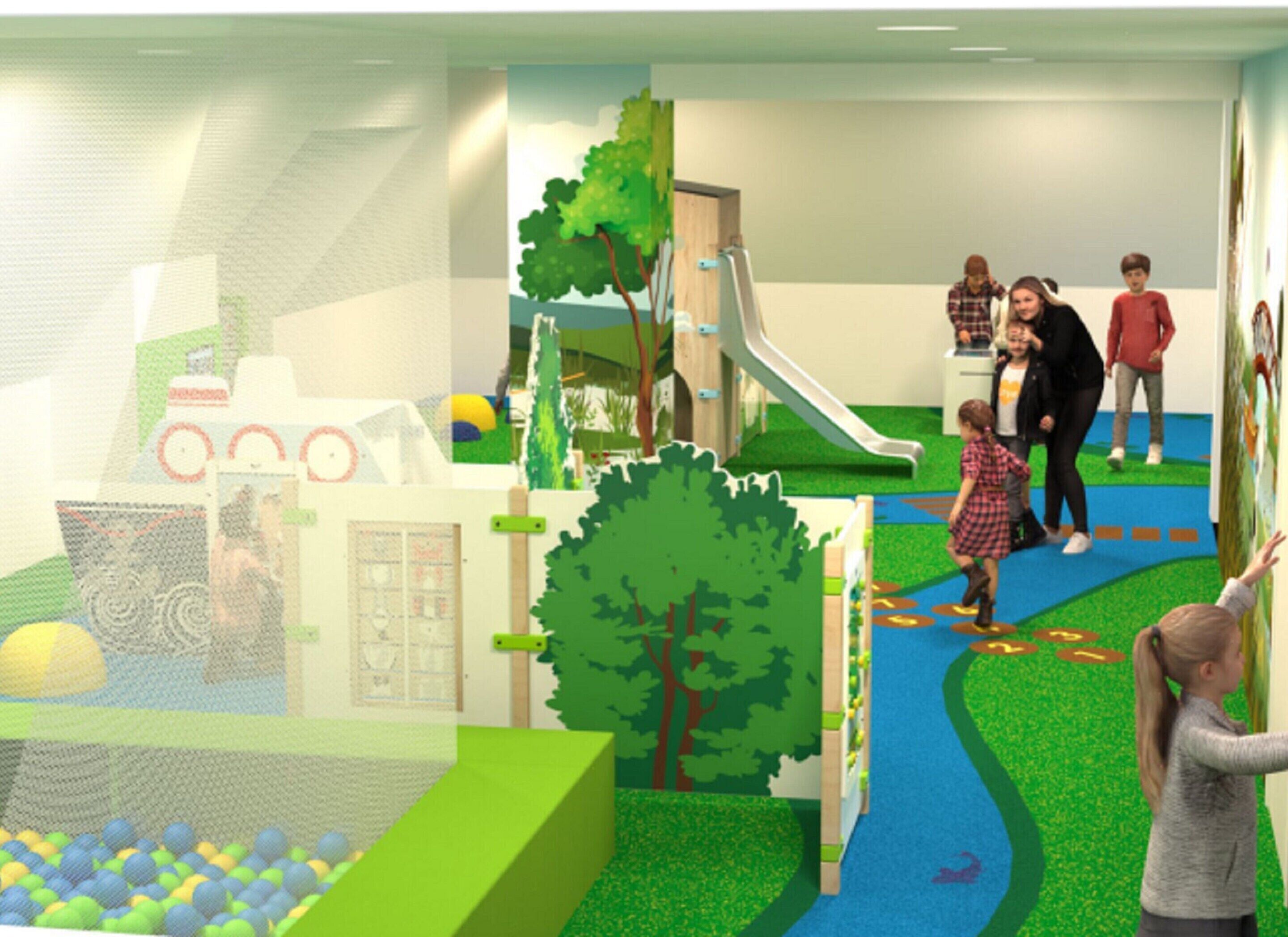 A children's play area with a slide, climbing structures, and a ball pit.