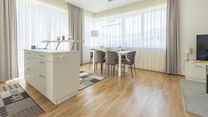 A modern, well-lit room with a kitchenette, dining area, and a TV. - Pleasant Chalet on the ski Slopes (Sankt Lambrecht)