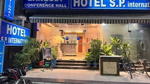 Un hotel con un letrero destacado para la "Sala de Banquetes y Conferencias" y "Hotel S.P. International".