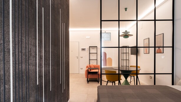 A modern interior with a dining area, a sofa, and a bed. - Loft 404 by Wonderful Italy (Bari)