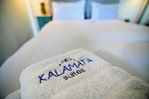 A white towel with "KALAMATA suites" embroidered on it. - Ilektra Studio Apt with Sea View (Kalamata)