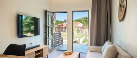 Deluxe Apartment, 1 Bedroom, Garden View | Living area | Flat-screen TV