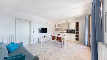 Apartment, Balcony, Partial Lake View | Living area | 35-inch flat-screen TV with digital channels