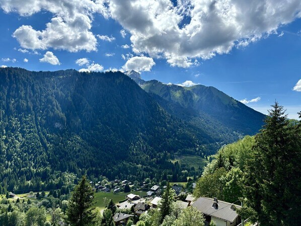 A mountainous landscape with a village nestled in the valley.