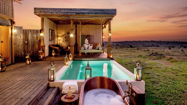A wooden deck with a pool, a hot tub, and a seating area with a view of the horizon. - One Nature Mara River (Serengeti)